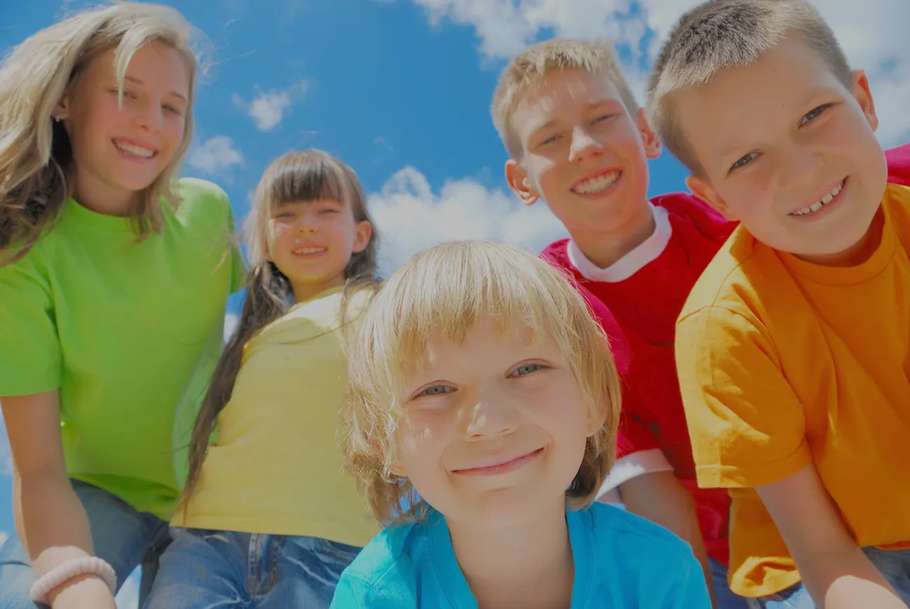 Five smiling children on a sunny day